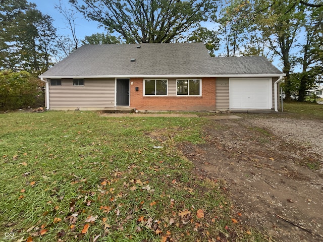 view of front of home with a front yard and a garage