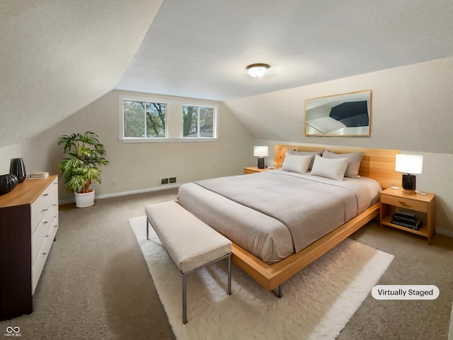 carpeted bedroom with vaulted ceiling