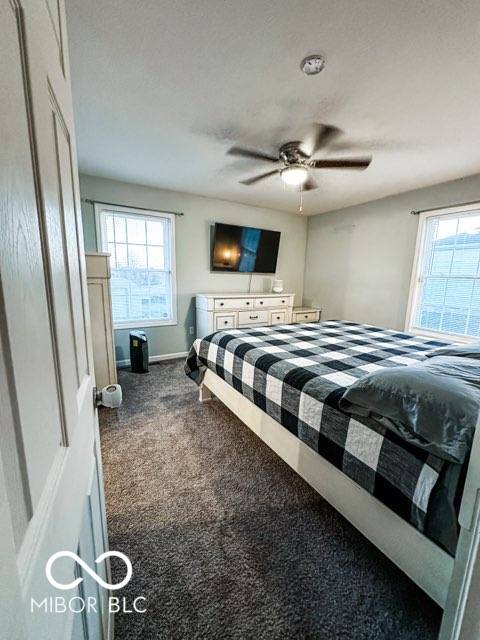 carpeted bedroom with ceiling fan