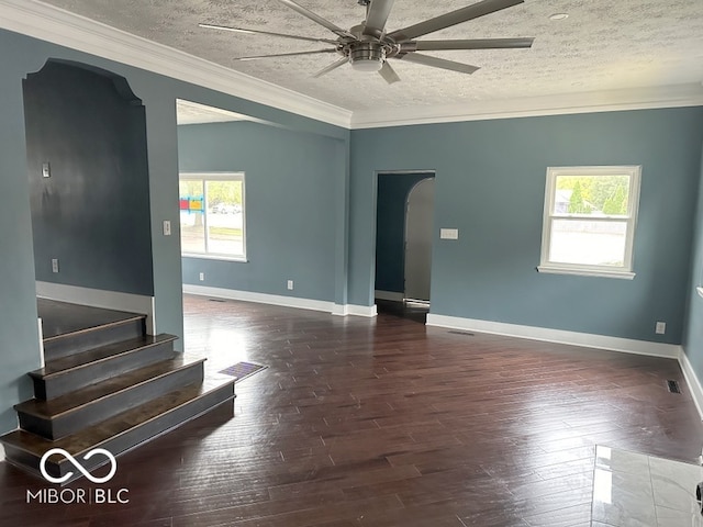 unfurnished room with a healthy amount of sunlight, a textured ceiling, and dark hardwood / wood-style floors