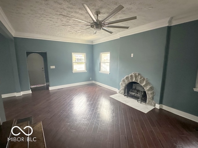 unfurnished living room with ceiling fan, a textured ceiling, ornamental molding, and dark hardwood / wood-style floors