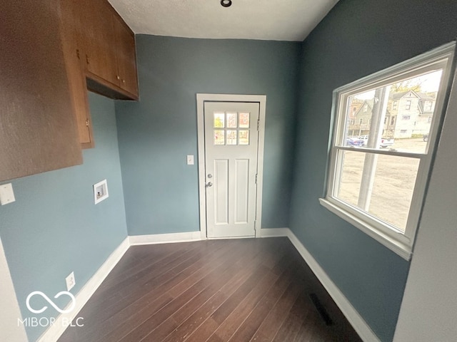 laundry area with cabinets, washer hookup, and dark hardwood / wood-style flooring