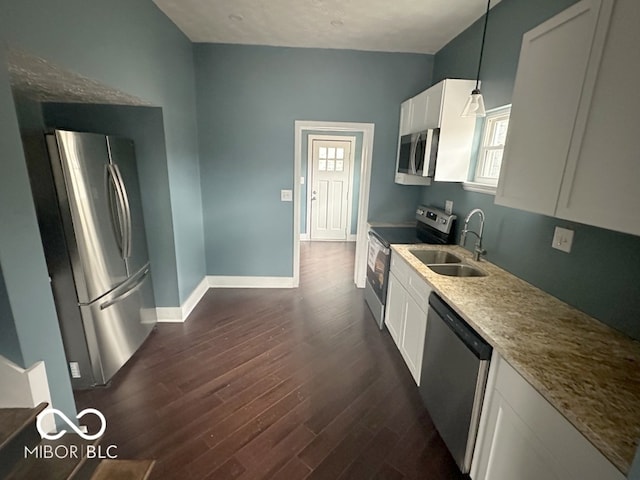 kitchen featuring sink, pendant lighting, white cabinetry, appliances with stainless steel finishes, and dark hardwood / wood-style flooring