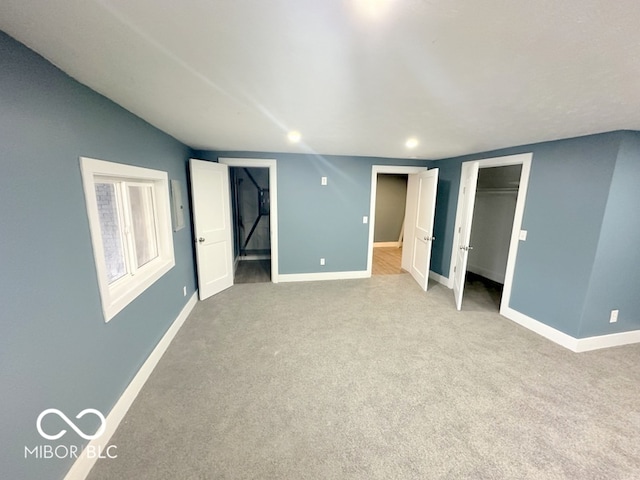 unfurnished bedroom with light colored carpet