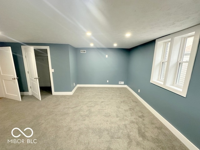 interior space with a spacious closet and light colored carpet