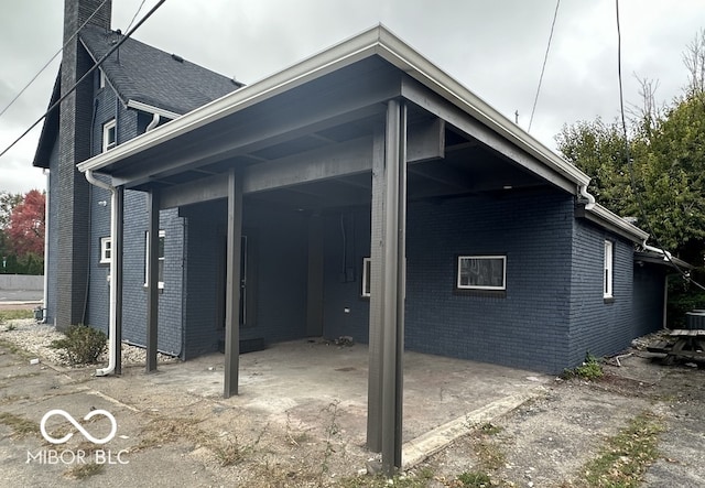 view of property exterior with a carport