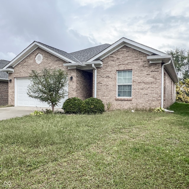 ranch-style house with a garage and a front lawn