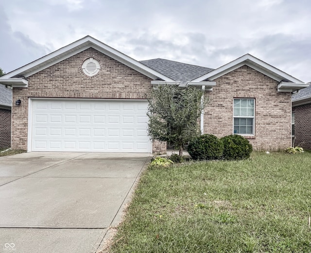 view of front of house with a garage and a front lawn