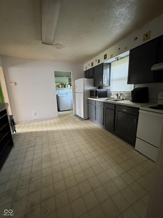 3231 W State Road 32, Westfield, IN 46074 - kitchen with white appliances, washing machine and dryer, light countertops, light floors, and a textured ceiling