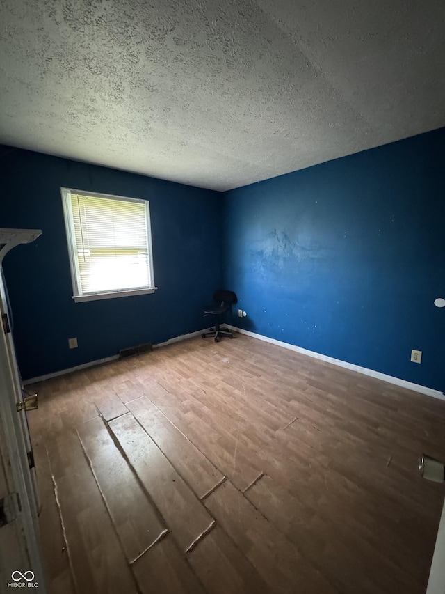 3231 W State Road 32, Westfield, IN 46074 - spare room featuring a textured ceiling and wood finished floors