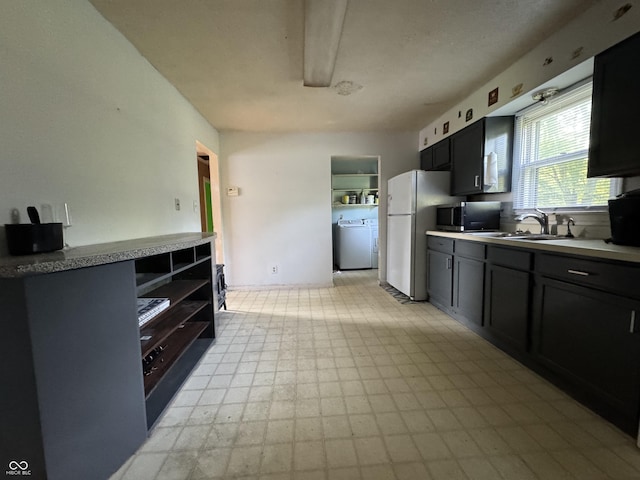 3231 W State Road 32, Westfield, IN 46074 - kitchen with freestanding refrigerator, washer / dryer, stainless steel microwave, light floors, and light countertops