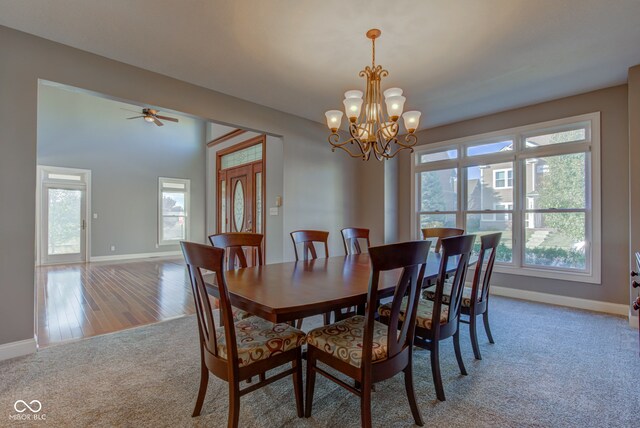 7189 Lockford N, Avon, IN 46123 - dining room featuring baseboards, light colored carpet, and a chandelier
