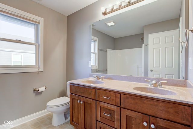 7189 Lockford N, Avon, IN 46123 - bathroom with baseboards, healthy amount of natural light, toilet, and double vanity