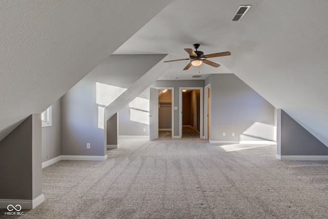 7189 Lockford N, Avon, IN 46123 - additional living space featuring ceiling fan, carpet, baseboards, lofted ceiling, and a textured ceiling