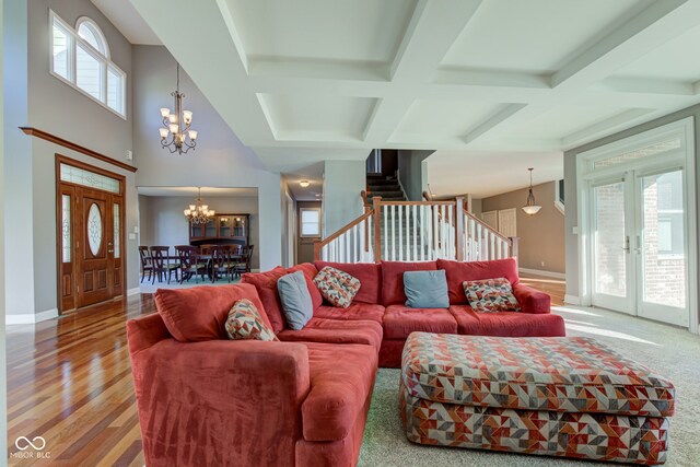 7189 Lockford N, Avon, IN 46123 - living area featuring a chandelier, coffered ceiling, stairway, wood finished floors, and beam ceiling