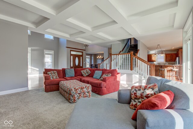 7189 Lockford N, Avon, IN 46123 - living room featuring a chandelier, coffered ceiling, beamed ceiling, stairs, and baseboards