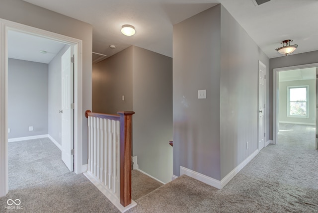 hallway featuring light colored carpet