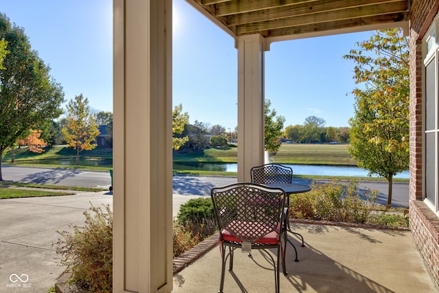 view of patio with a water view