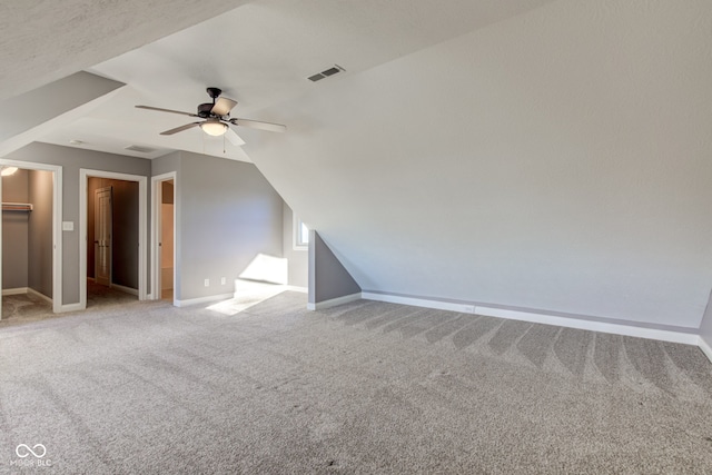 additional living space featuring ceiling fan, light carpet, and lofted ceiling