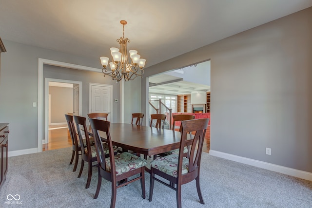 dining area with a chandelier and light carpet