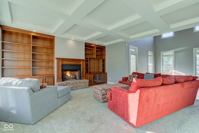 living room featuring light colored carpet, built in shelves, and a brick fireplace