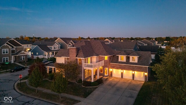 7189 Lockford N, Avon, IN 46123 - view of front of house with a balcony, driveway, a residential view, and an attached garage