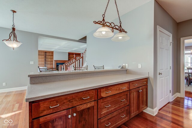 7189 Lockford N, Avon, IN 46123 - kitchen featuring wood finished floors, pendant lighting, light countertops, and baseboards