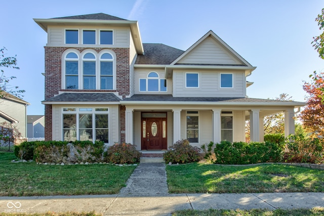 view of front of property with a front yard and covered porch