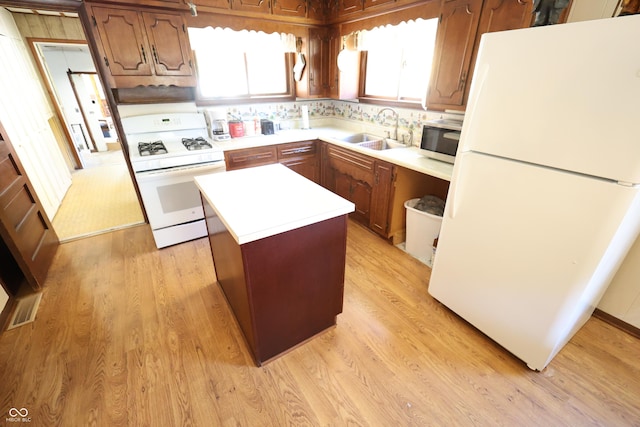 9540 E Brentmoore Rd, Brazil, IN 47834 - kitchen featuring white appliances, a sink, a kitchen island, light countertops, and light wood-style flooring