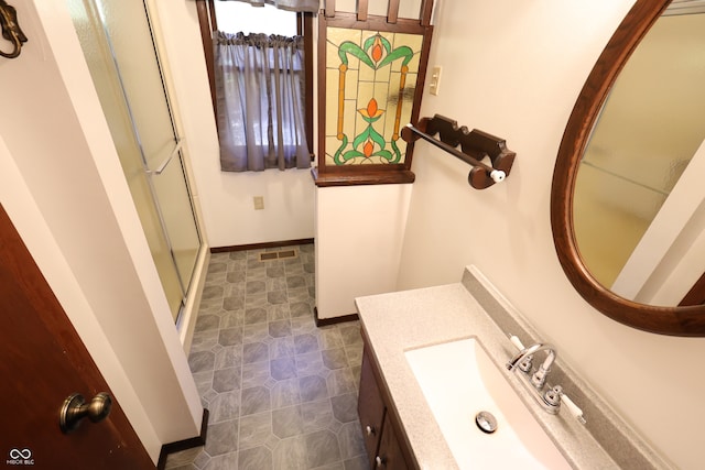 bathroom with vanity and a shower with door