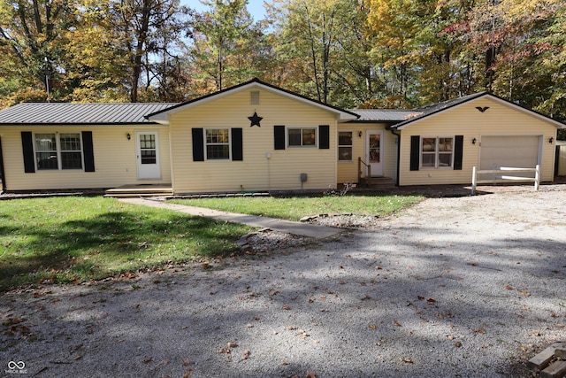 9540 E Brentmoore Rd, Brazil, IN 47834 - ranch-style house with an attached garage, metal roof, a front yard, and asphalt driveway