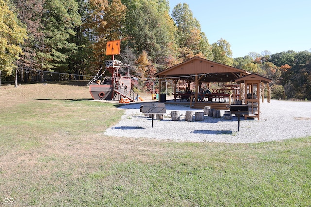 exterior space with a playground, a lawn, and a gazebo