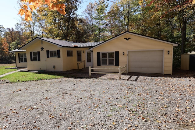 9540 E Brentmoore Rd, Brazil, IN 47834 - ranch-style home featuring gravel driveway, an attached garage, metal roof, and a standing seam roof