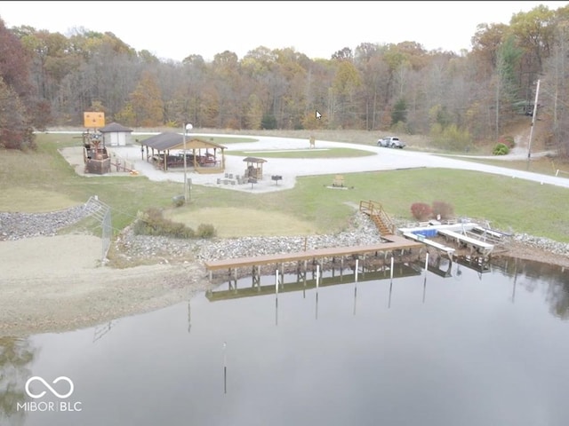 9540 E Brentmoore Rd, Brazil, IN 47834 - dock featuring a wooded view, a water view, and a lawn