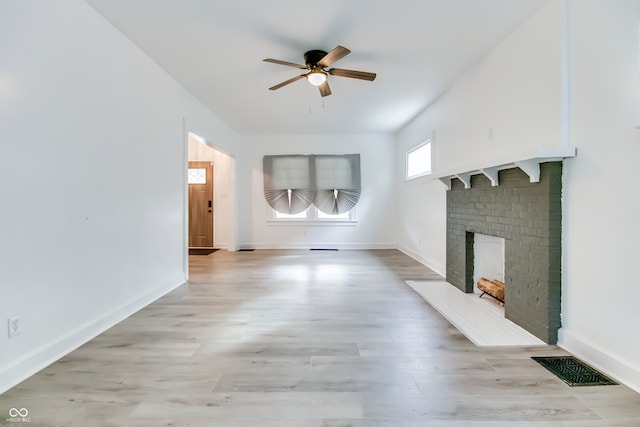 unfurnished living room with ceiling fan, light hardwood / wood-style flooring, and a fireplace