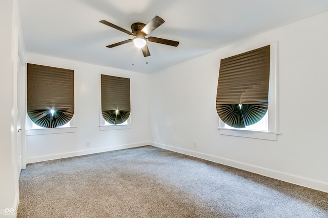 empty room with ceiling fan and carpet flooring