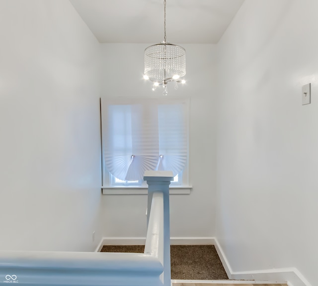 interior space featuring carpet and an inviting chandelier