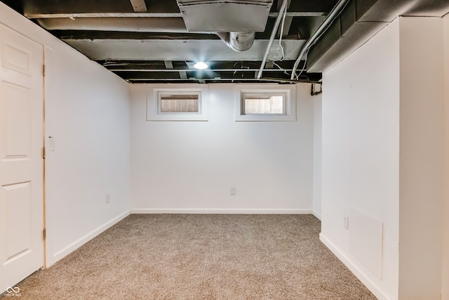 basement featuring light carpet