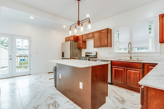 kitchen featuring french doors, stainless steel appliances, plenty of natural light, and a kitchen island