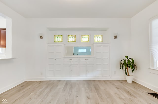 unfurnished living room featuring light hardwood / wood-style flooring and plenty of natural light