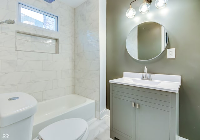 full bathroom featuring vanity, toilet, and tiled shower / bath