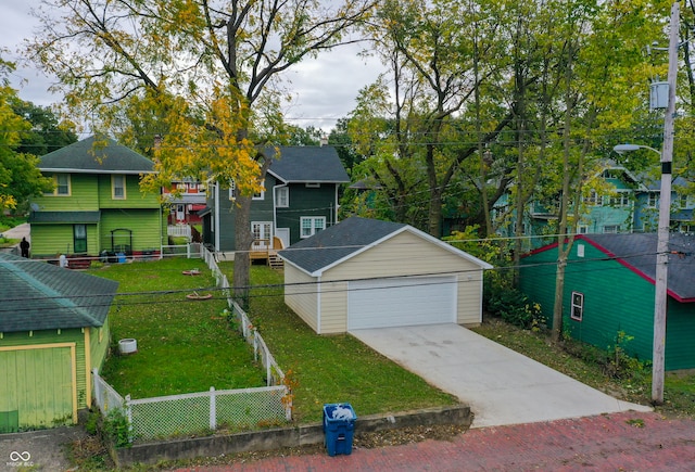 view of front of home featuring a front yard, an outdoor structure, and a garage