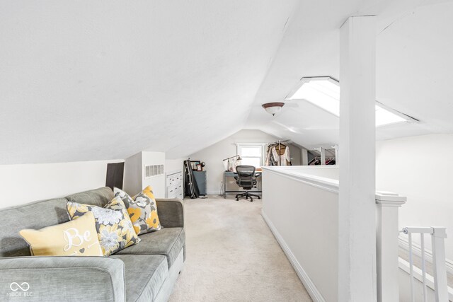 interior space with vaulted ceiling and light carpet