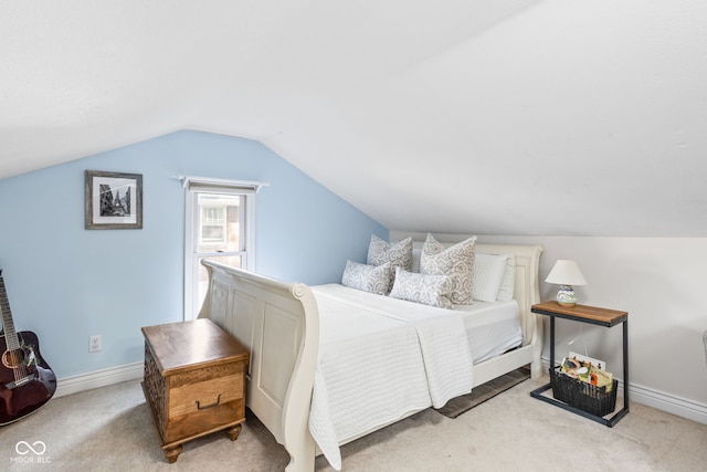 carpeted bedroom with vaulted ceiling