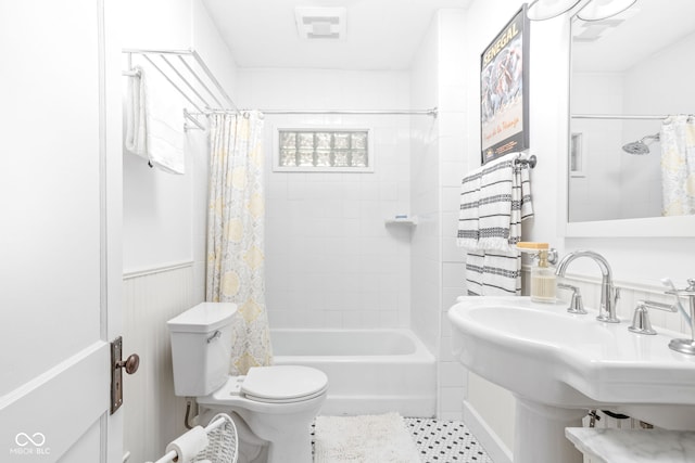 full bathroom with toilet, sink, and shower / tub combo