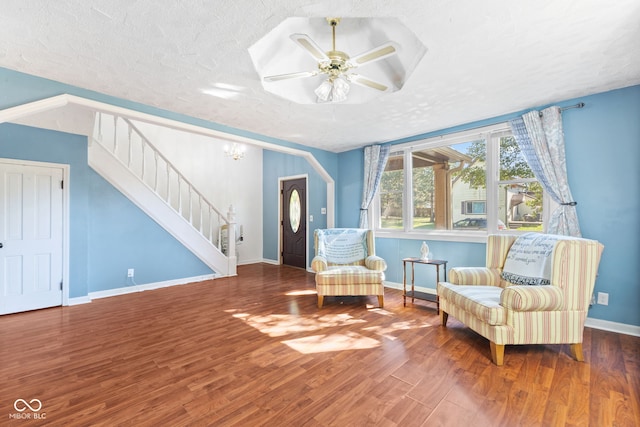 sitting room with hardwood / wood-style floors, a textured ceiling, and ceiling fan