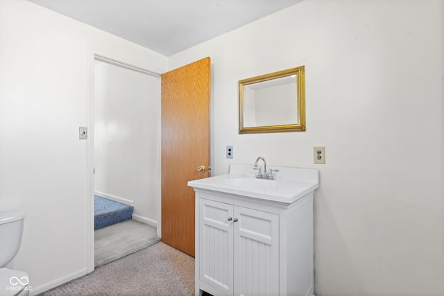 bathroom featuring toilet and vanity