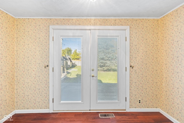 entryway featuring french doors, ornamental molding, and hardwood / wood-style floors