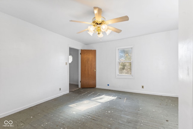 unfurnished room featuring ceiling fan and dark hardwood / wood-style flooring