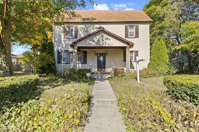 view of front of property with a porch and a front yard